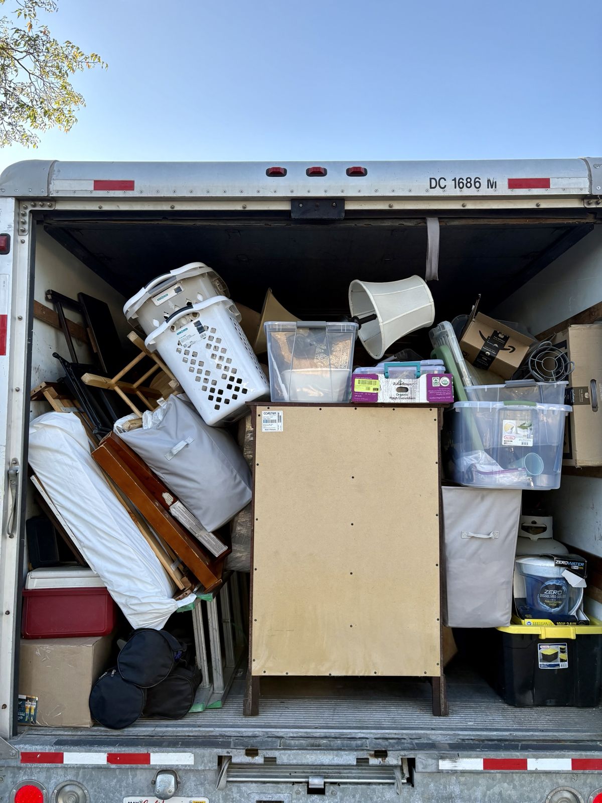 Box truck packed with furniture and household items from a move-out