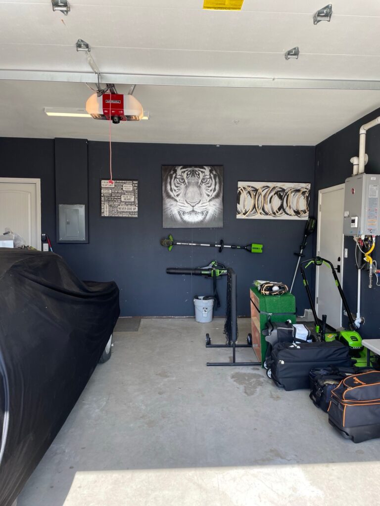Garage after a cleanout with the floor cleared and tools organized