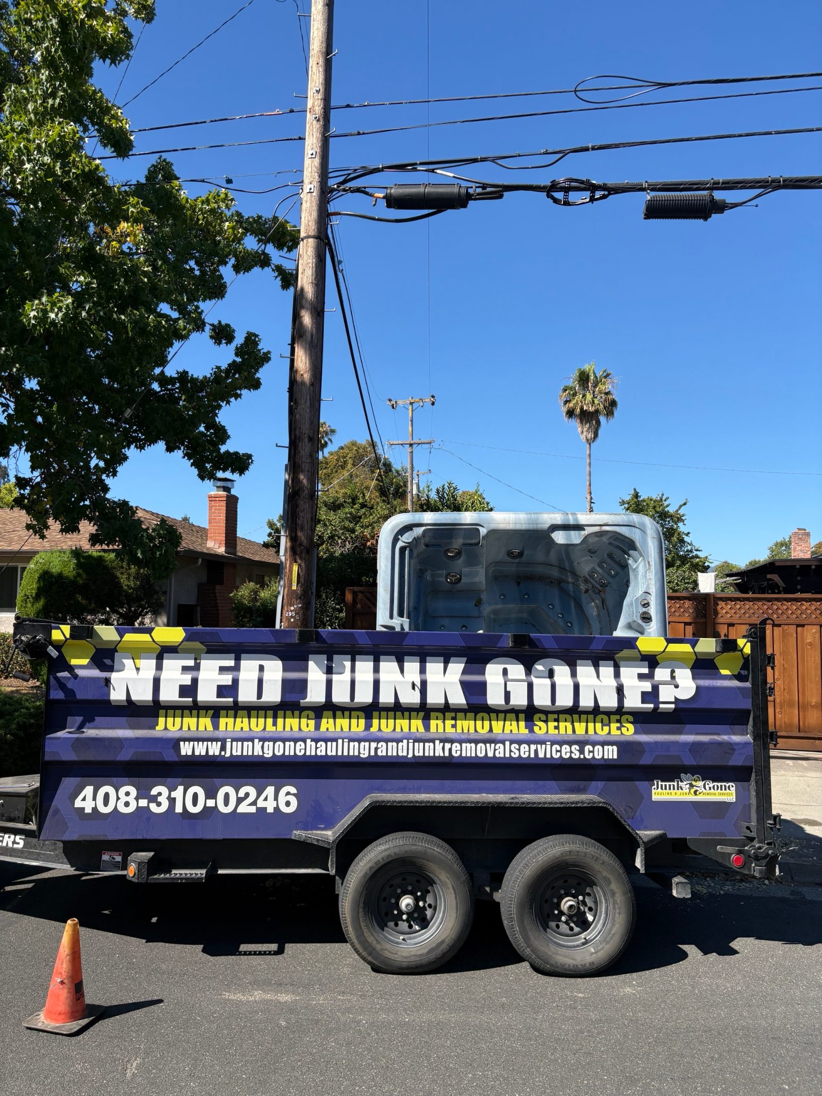 Hot tub loaded into the Junk Gone dump trailer for disposal