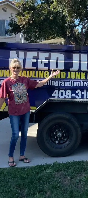 Customer smiling next to the Junk Gone dump trailer