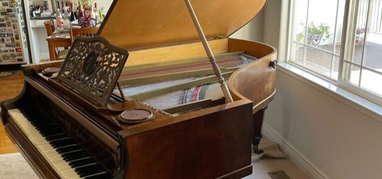Grand piano in a living room before removal