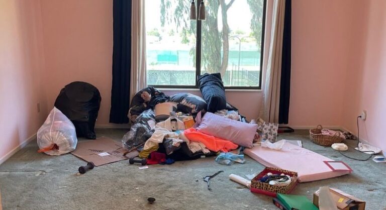 Bedroom floor covered in belongings before cleanout