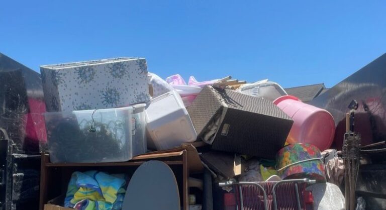 Trailer stacked with boxes and furniture from a whole-home cleanout