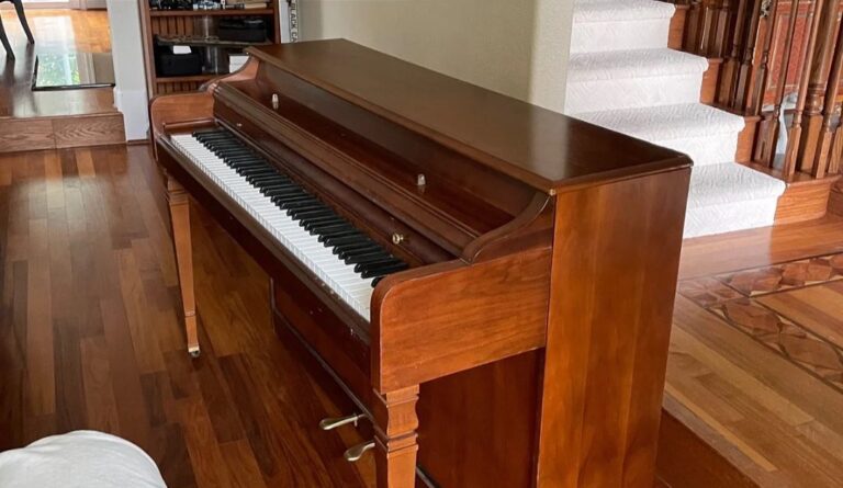 Upright piano in a home before removal