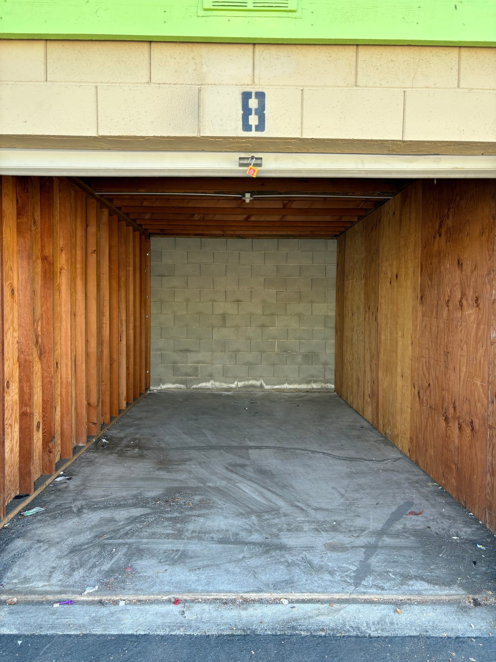 Same storage unit after cleanout, empty and swept