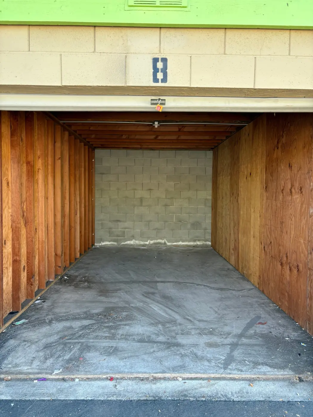 Same storage unit after cleanout, empty and swept